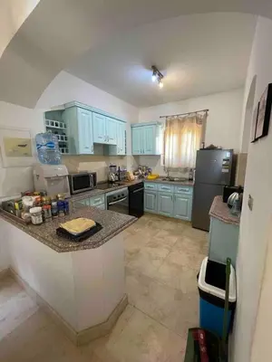 a kitchen with blue cabinets and a counter top at Spacious Villa with private pool-Gouna in Hurghada