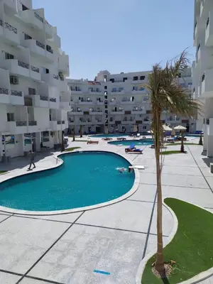 an empty swimming pool in front of a building at Tiba View flat near pool in Hurghada