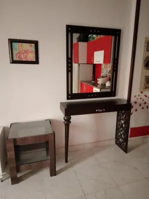 a dressing table with a mirror and a stool at Tiba View flat near pool in Hurghada