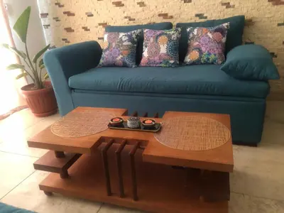 a living room with a blue couch and a coffee table at 1 Bed Apartment with Public Pool HotTub & PetsOk in Hurghada