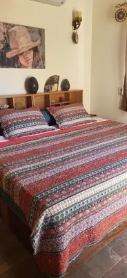 a bedroom with two beds with a blanket on them at 1 Bed Apartment with Public Pool HotTub & PetsOk in Hurghada