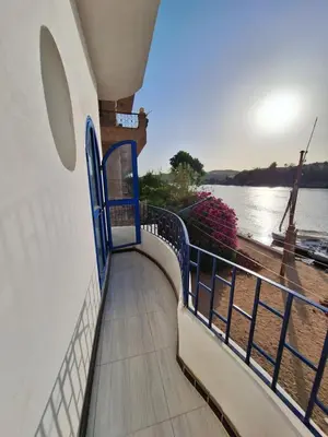 a balcony with a view of the water at NOBATiA Guest House 2 in Aswan