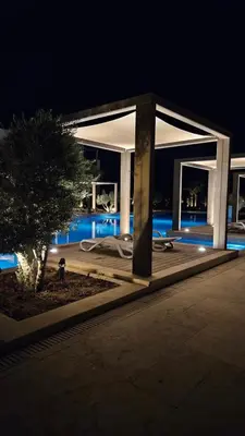a white pavilion with a pool at night at El Gouna Mangroovy Residence Sea View - kitesurfing in Hurghada