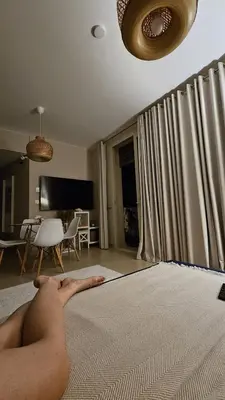 a naked man laying on a bed in a living room at El Gouna Mangroovy Residence Sea View - kitesurfing in Hurghada