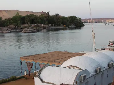 a boat is docked in a body of water at Ajwa Guest House in Aswan