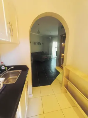a kitchen with a sink and an archway in a room at Royal Beach Hurghada in Hurghada