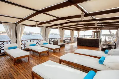 a room with couches and chairs on a boat at Farouz El Nil II Nile Cruise - Every Monday from Luxor for 07 & 05 Nights in Luxor