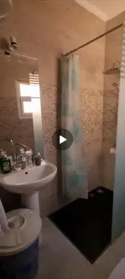 a bathroom with a toilet and a shower and a sink at A216 flat Al Makramia in Hurghada