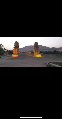 two large stoneoliths in the middle of a desert at Tibs mountain view in Al Aqālitah
