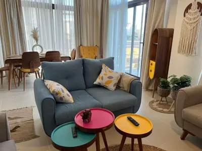 a living room with a blue couch and tables at Luxury 4 bedroom villa - Cyan ElGouna in Hurghada