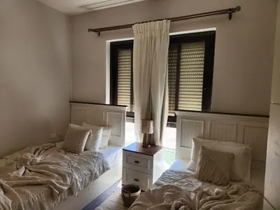 a bedroom with two beds and a window at Luxury 4 bedroom villa - Cyan ElGouna in Hurghada
