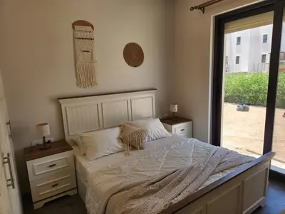 a bedroom with a bed and a large window at Luxury 4 bedroom villa - Cyan ElGouna in Hurghada