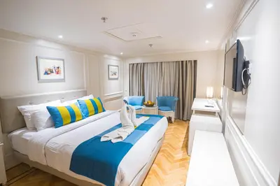 a hotel room with a bed and a television at 4-Day 3-Night Guided Nile Cruise from Aswan to Luxor every Monday, Wednesday & Friday Departures in Aswan