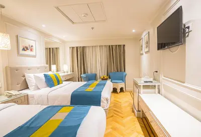 a hotel room with two beds and a flat screen tv at 4-Day 3-Night Guided Nile Cruise from Aswan to Luxor every Monday, Wednesday & Friday Departures in Aswan