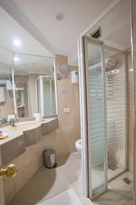 a bathroom with a shower and a sink and a toilet at 4-Day 3-Night Guided Nile Cruise from Aswan to Luxor every Monday, Wednesday & Friday Departures in Aswan