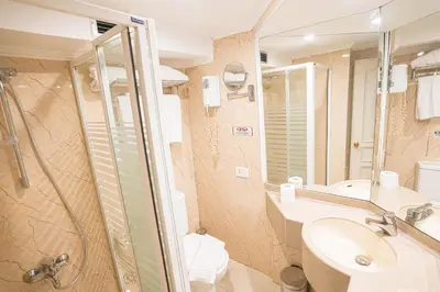 a bathroom with a shower and a sink and a toilet at 4-Day 3-Night Guided Nile Cruise from Aswan to Luxor every Monday, Wednesday & Friday Departures in Aswan