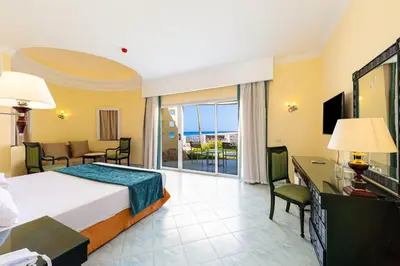 a hotel room with a bed and a balcony at Siva Golden Bay Makadi in Hurghada