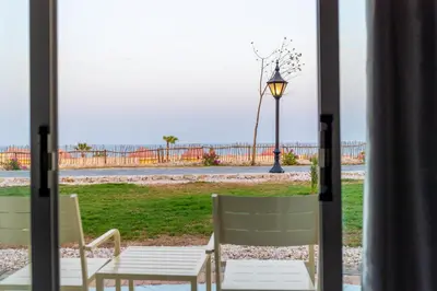 a patio with a table and chairs and a street light at Siva Golden Bay Makadi in Hurghada
