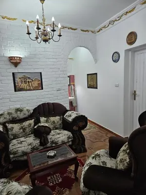 a living room with a couch and a table at Casa Helvetica in Luxor