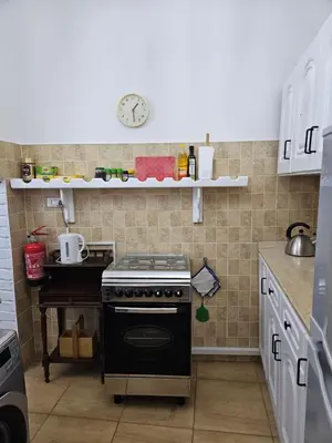 a small kitchen with a stove and a table at Casa Helvetica in Luxor