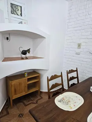 a black cat sitting on a shelf in a room at Casa Helvetica in Luxor