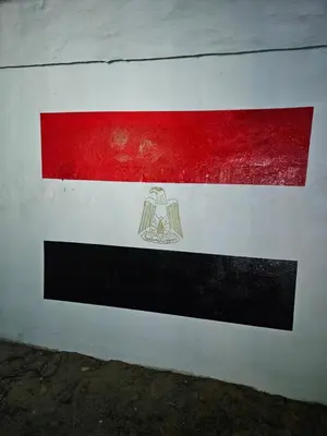 a red white and black flag on a wall at Casa Helvetica in Luxor