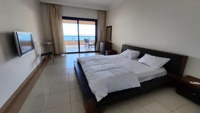a bedroom with a bed with a view of the ocean at apartment 2 bedrooms in the view in Hurghada