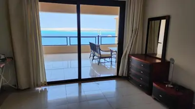 a living room with a view of the ocean at apartment 2 bedrooms in the view in Hurghada