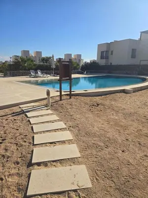 a stone pathway next to a swimming pool at El Gouna, Cyan 2-Bedroom Ground Floor in El Gouna