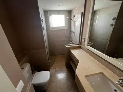 a bathroom with a toilet and a sink and a shower at El Gouna, Cyan 2-Bedroom Ground Floor in El Gouna