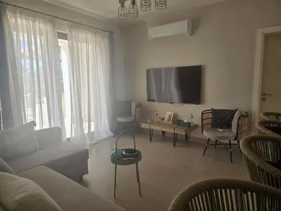 a living room with a couch and a tv at El Gouna, Cyan 2-Bedroom Ground Floor in El Gouna