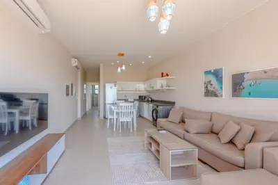 a living room with a couch and a table at Cozy 2BR in Cyan, El Gouna Swiming Pool Access in Hurghada