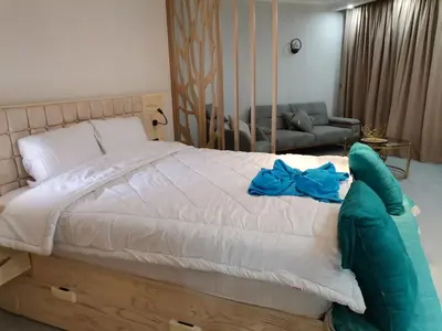 a bedroom with a large bed with a blue bow on it at Scandic resort سكانديك ريزورت in Hurghada