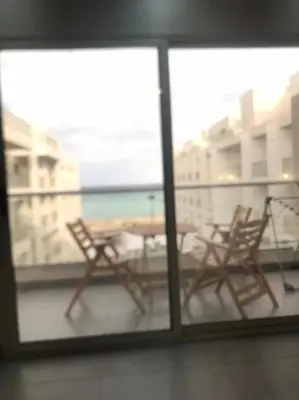 two chairs and a table on a balcony at Scandic resort سكانديك ريزورت in Hurghada