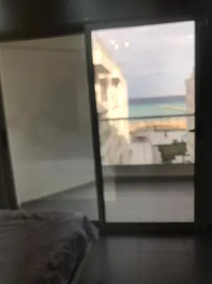 a room with a window with a view of a building at Scandic resort سكانديك ريزورت in Hurghada