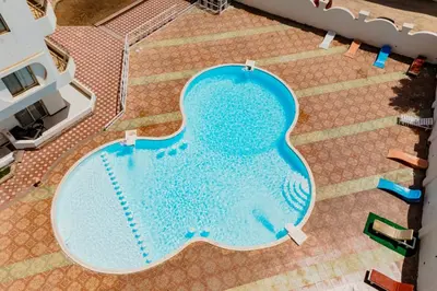 an overhead view of a large swimming pool at Al makramia compound in Hurghada