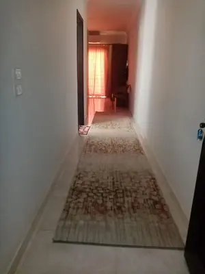 an empty hallway with rugs on the floor in a house at Al makramia compound in Hurghada