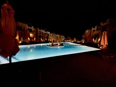 a large swimming pool at night with lights at Mangroovy M7-4A-03 in Hurghada