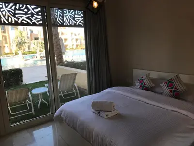 a bedroom with a bed and a large window at Mangroovy M7-4A-03 in Hurghada