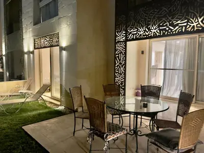 a patio with a table and chairs and a window at Mangroovy M7-4A-03 in Hurghada