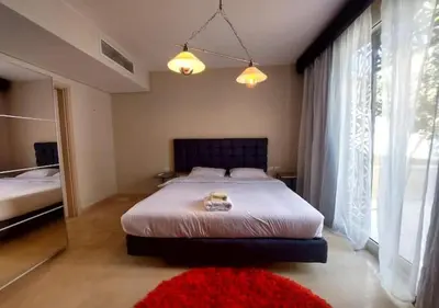 a bedroom with a bed and a large window at Warm 1BR with at Mangroovy, El-Gouna M1-7B in Hurghada