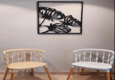 two white chairs sitting next to a wall with a picture at Warm 1BR with at Mangroovy, El-Gouna M1-7B in Hurghada