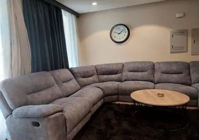 a living room with a couch and a clock on the wall at Warm 1BR with at Mangroovy, El-Gouna M1-7B in Hurghada