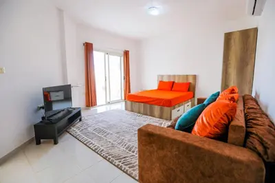 a living room with a couch and a bed at la bonita studio in Hurghada