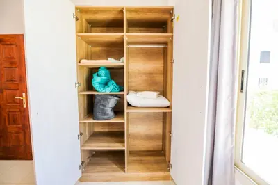 a closet with wooden shelves in a room at la bonita studio in Hurghada