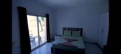 a bedroom with a bed and a large window at la bonita studio in Hurghada