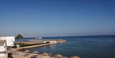 a view of a beach with umbrellas and the ocean at Chalet front the beach in Hurghada