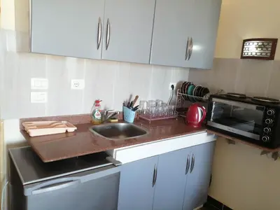 a kitchen with a sink and a microwave at Chalet front the beach in Hurghada