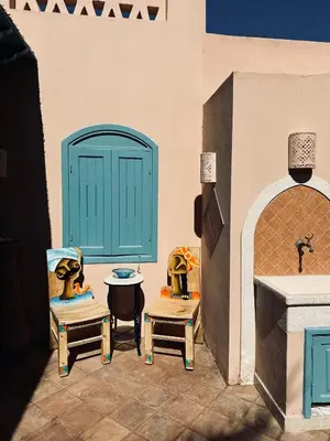 a room with two chairs and a table and a door at Casa Della Laguna in Gouna in Hurghada