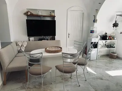 a living room with a couch and a table and chairs at Casa Della Laguna in Gouna in Hurghada